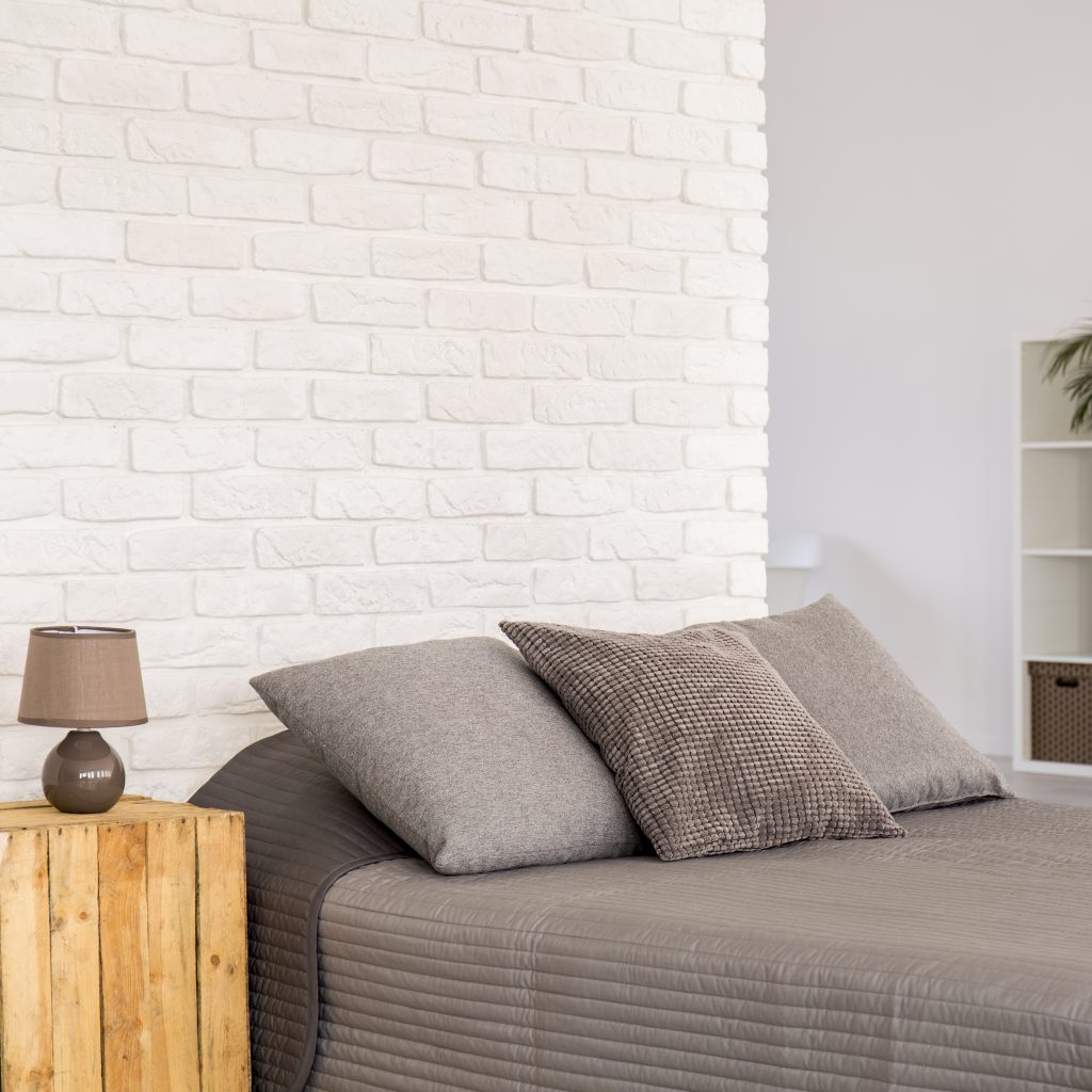 White brick wall in new modern bedroom